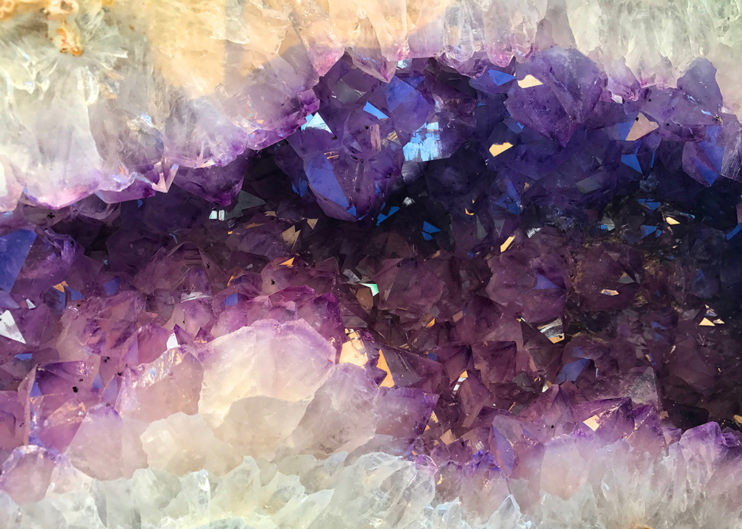 a close up photo of an emethyst geode showing dark purple and white crystals